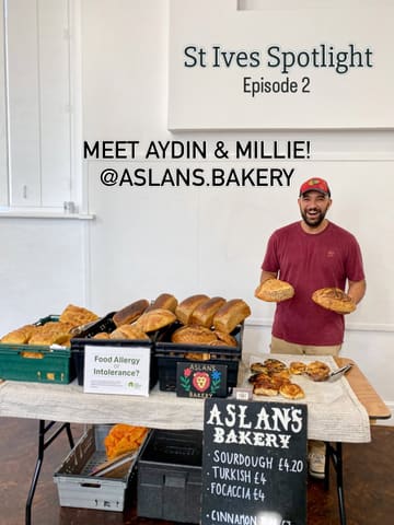 A promotional image for a local artisan bakery, featuring the owner holding two loaves of sourdough at a market stall. The image includes text overlays introducing the business and the owners.