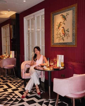 A polished lifestyle shot featuring a guest dining at The Pem, highlighting the restaurant's elegant interior design and sophisticated atmosphere.