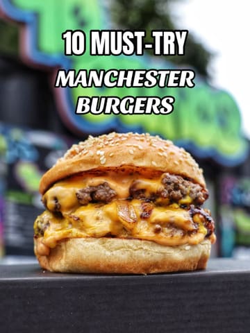 A promotional graphic featuring a close-up shot of a double cheeseburger with caramelized onions, overlaid with the text '10 MUST-TRY MANCHESTER BURGERS'. The image appears to be a digital creation or heavily processed, lacking the natural texture of a real food photograph.