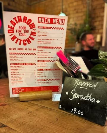 A casual, slightly cluttered shot of a restaurant menu and a reserved sign on a table, likely taken during a date night. The image serves as a functional record of the visit rather than a polished marketing asset.