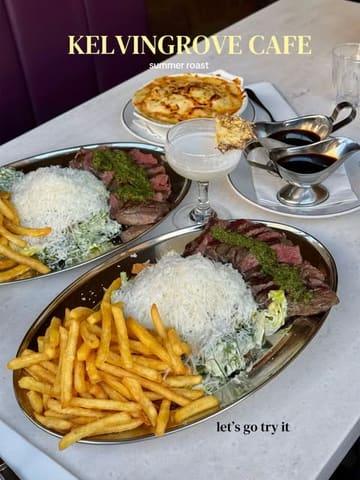 A flat-lay overhead shot of a 'summer roast' meal at Kelvingrove Cafe, featuring steak, fries, salad, a cocktail, and a side of mac and cheese.