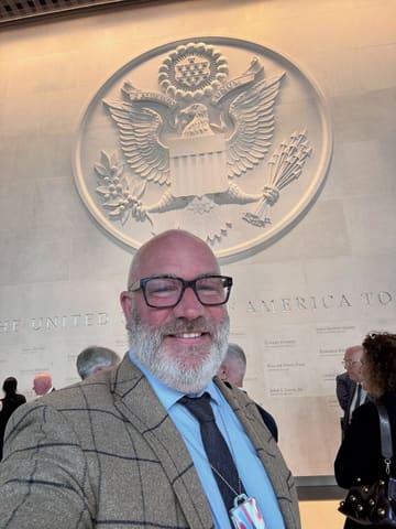 A selfie of a creator attending an event at the United States Embassy in London, highlighting a trade partnership and the promotion of U.S. beef and BBQ culture.