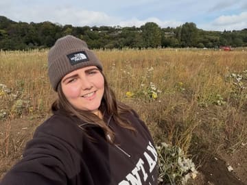A selfie taken by a creator at a pumpkin patch, capturing an autumn lifestyle vibe.