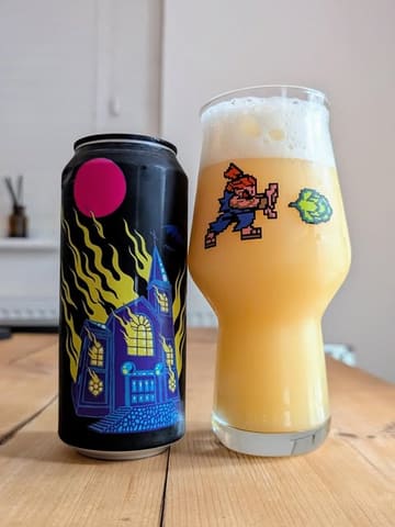 A clean, professional product shot featuring a can of 'Unholy Church' TIPA alongside a glass of the poured beer. The lighting is soft and even, effectively highlighting the hazy texture of the beer and the label design without creating distracting reflections.