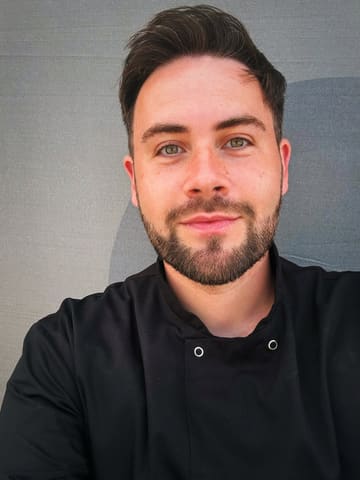 A high-quality, well-lit portrait of a chef, likely taken at a food festival. The image is clear, professional, and focuses on the individual, conveying a sense of expertise and approachability.