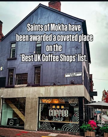 A static shot of the exterior of 'Saints of Mokha' coffee shop on a cloudy day, featuring text overlay announcing their inclusion in a 'Best UK Coffee Shops' list.