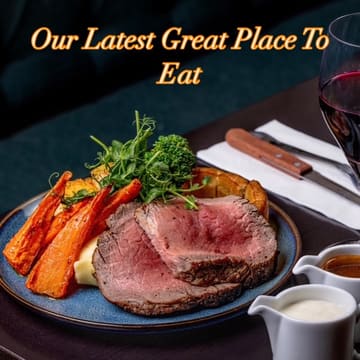 A professionally captured, well-lit image of a traditional Sunday roast dinner, featuring sliced roast beef, roasted carrots, broccoli, and a Yorkshire pudding, served with gravy and horseradish sauce, accompanied by a glass of red wine.