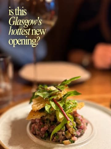 A high-quality, atmospheric close-up shot of a beef tartare dish served at a new restaurant in Glasgow, accompanied by text overlay questioning if it is the city's hottest new opening.