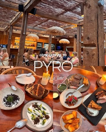 A collage-style social media post featuring an atmospheric shot of a restaurant patio and a top-down view of a table filled with various Greek dishes, promoting a visit to Pyro.