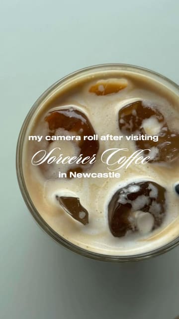 A clean, top-down, aesthetically pleasing shot of an iced coffee, likely taken at Sorcerer Coffee in Newcastle. The image is bright, well-lit, and focuses on the drink, creating an inviting atmosphere for a casual coffee stop.