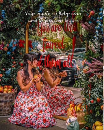 A high-quality, thematic photograph capturing a floral installation in London, likely part of the Chelsea or Belgravia in Bloom events. The image features a creator posing in front of a mirror surrounded by flowers and apples, creating a fairytale aesthetic that is visually engaging and on-brand for the event.