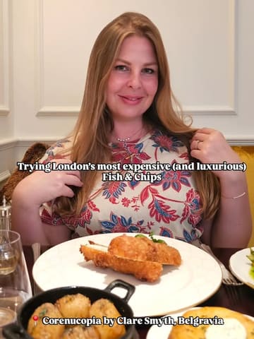 A high-quality, well-composed image featuring a diner at a Michelin-starred restaurant, showcasing a luxurious take on fish and chips. The lighting is soft and flattering, and the composition effectively balances the subject with the food.