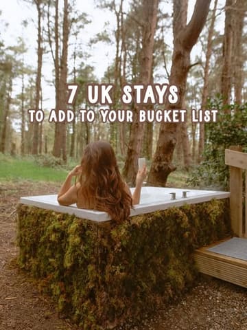 A visually appealing, atmospheric lifestyle shot featuring a person in a moss-covered outdoor bathtub in a forest setting, used as a cover image for a listicle about UK staycations.