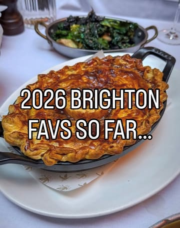 A high-quality, appetizing close-up shot of a golden-brown, flaky-crust pie served in a cast-iron skillet, accompanied by a side of greens in the background. The image is well-composed and clearly highlights the texture and quality of the food.