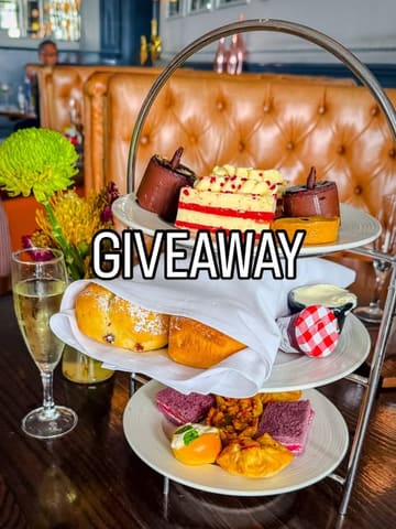 A promotional image for an afternoon tea giveaway at a hotel, featuring a tiered stand with various pastries and sandwiches.
