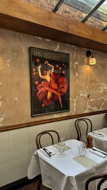 A montage of a French bistro in West Hampstead, showcasing the interior, signature cocktails, and a variety of dishes including duck confit, steak, and chocolate mousse.