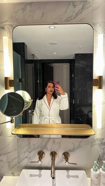 A montage showcasing a boutique hotel stay, highlighting the room amenities, bathroom, and room service dining experience.