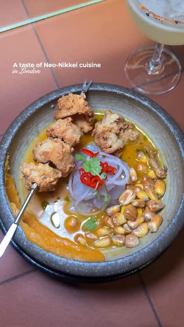 A high-quality, visually appealing reel showcasing a variety of Neo-Nikkei and Cantonese fusion dishes at a restaurant in Notting Hill. The video features close-up shots of food preparation, plating, and the final dishes, interspersed with a brief shot of the creator enjoying the meal.
