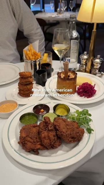 A short, punchy montage showcasing various dishes at Fitzgerald's, an Irish-American restaurant in London, including steak tartare, Caesar salad, fried chicken, and dessert.