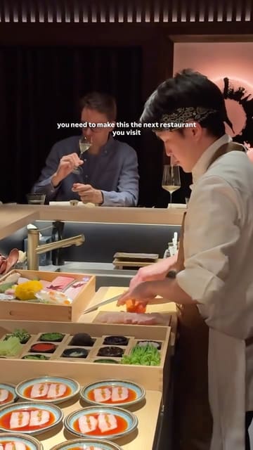 A high-quality, intimate look at a 12-course omakase dining experience in London. The video features close-up shots of chefs preparing delicate dishes like caviar-topped nigiri, sashimi, and wagyu, alongside sake pairings and views of the city skyline.