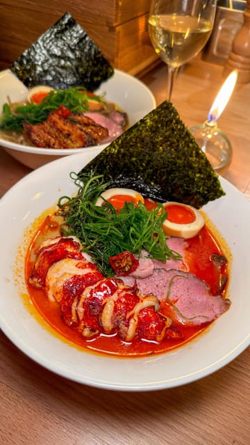 A creator visits Robin's Ramen, located within the Supermarket of Dreams in London. The video features a variety of dishes including duck gyoza, prawn bao, bream, lobster ramen, and tonka ice cream, highlighting the quality and value of the menu.