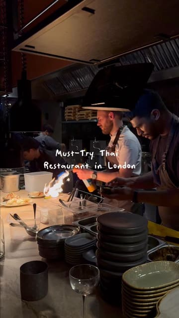 A review of a Thai restaurant in Fitzrovia, London, focusing on their signature Khao Soi dish, starters, and desserts, highlighting the atmosphere and kitchen action.