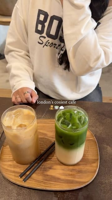 A short, aesthetic montage showcasing the interior and drinks at a London cafe called FILTRD. The video uses slow, deliberate shots to highlight the minimalist decor and the presentation of an iced coffee and a matcha latte.