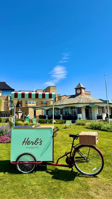 A short, montage-style video showcasing 'Herbs' at the Old Course Hotel in St Andrews. The video features shots of the cafe's exterior, interior, and menu items, including a salmon croissant and matcha, set to music with text overlays.