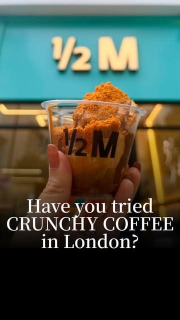 A short, high-energy video showcasing the assembly of a 'Crunchy Coffee' dessert at Half Million in London, featuring vanilla ice cream, espresso, Nutella, Biscoff sauce, and Biscoff crumb.