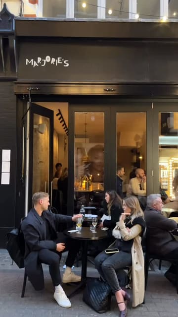 A stylish, well-edited reel showcasing Marjorie's, a Parisian-inspired restaurant and wine bar in Soho. The video features a montage of the venue's intimate interior, staff preparing drinks, and close-ups of various seasonal French dishes, effectively communicating the relaxed yet sophisticated atmosphere.
