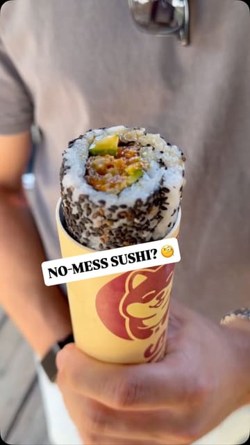 A short, punchy video showcasing a unique 'sushi pop' concept at Boxpark Shoreditch, demonstrating the convenience of the packaging and highlighting the prawn tempura roll.