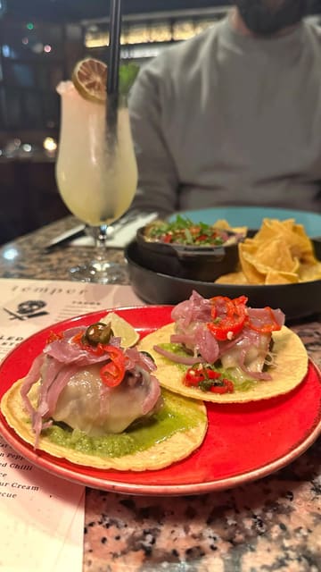 A short, visually focused montage showcasing the food and interior of Temper restaurant in London. The video highlights the open grill, various steak dishes, and their signature tacos, using high-quality, well-lit shots to create an appetizing presentation.