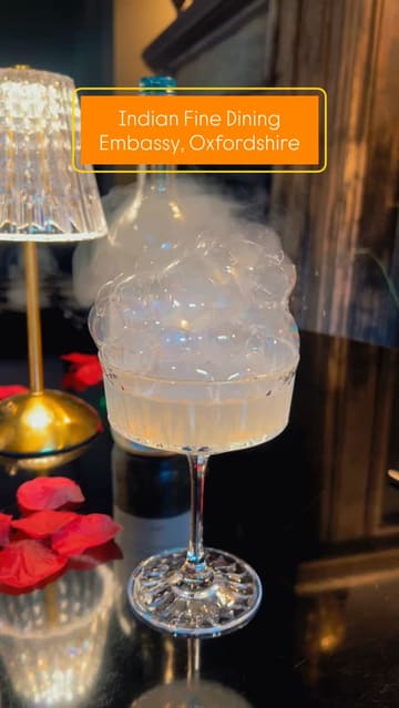 A short, polished montage showcasing the Indian dining experience at Embassy, located within The Chesterton Hotel. The video features close-up shots of cocktails, pani puri, thali sets (butter chicken and lamb rogan josh), and a pistachio cheesecake, emphasizing the presentation and intimate atmosphere of the venue.