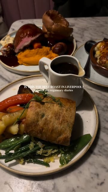 A short, edited montage showcasing a Sunday roast experience at Little Leaf in Liverpool, focusing on a vegan mushroom Wellington, gravy pouring, and the restaurant's interior.