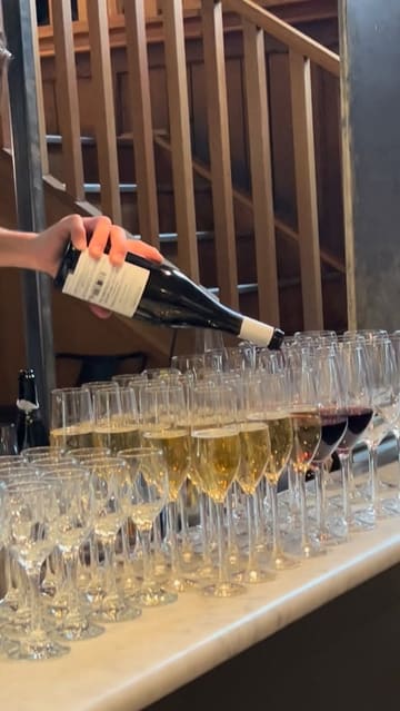 A short, energetic montage capturing an event at Mercato Metropolitano celebrating a partnership with the Friuli Venezia Giulia region. The video features shots of wine pouring, various Italian food items like prosciutto and frico, live music, and the bustling atmosphere of the venue.