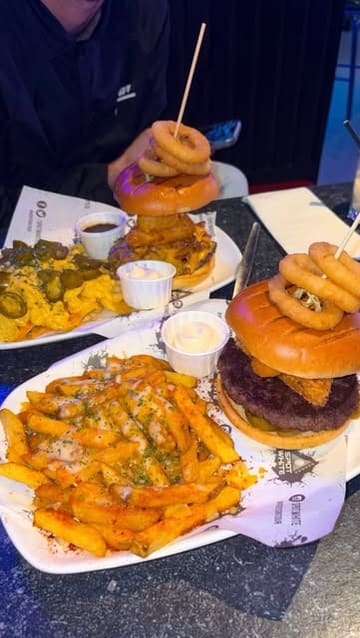 A montage-style video showcasing a visit to Spot White West, a venue featuring pool, darts, and a casual dining menu. The video highlights the atmosphere, the food and drink offerings, and the unique robot server.