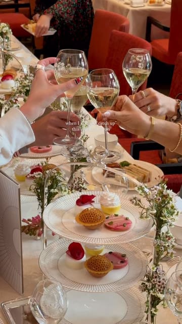A high-quality, polished reel showcasing the 'Peninsula in Bloom' afternoon tea service at The Peninsula London. The video features elegant shots of the dining room, a live piano player, close-ups of the tea service, pastries, and champagne, as well as a glimpse of a dog in the hotel.