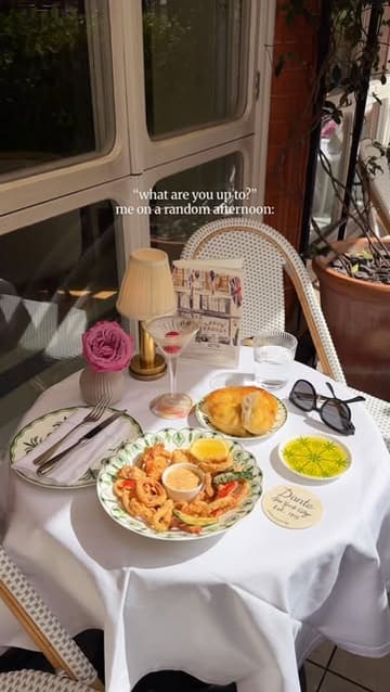A short, aesthetic montage showcasing the dining experience at a restaurant in Mayfair, featuring cocktails, fried seafood, dessert, and live piano music on a terrace.