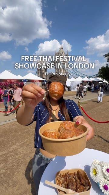 A vibrant vlog-style reel promoting a free Thai festival held at Potters Fields Park in London. The video features a variety of street food stalls, cultural performances, artisan crafts, and drinks, set against the backdrop of Tower Bridge. The creator provides a quick tour of the offerings, highlighting specific food items and the overall event atmosphere.