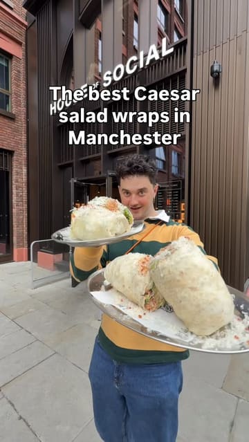 A high-energy food review featuring a massive Caesar salad wrap from Dough Religion in Manchester. The creator highlights the size and value of the wrap, performs a '5-bite' eating challenge, and provides a humorous, engaging commentary throughout the process.