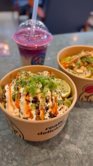 A short, punchy video showcasing Korean-inspired lunch bowls and a purple latte at Grounded Kitchen, featuring close-ups of the food and a brief look at the restaurant interior.