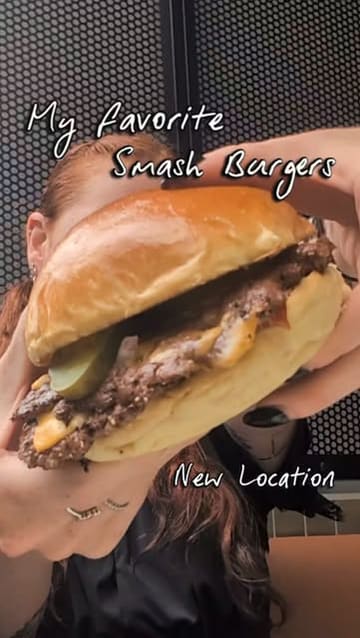 A short, energetic vlog-style video featuring a visit to a new Shakedown restaurant location. The creator highlights the menu items, including a smash burger, chicken tenders, fries, various dips, and a cheesecake dessert, while providing a brief tour of the new space.