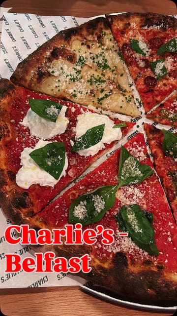 A vlog-style review of Charlie's pizza restaurant, featuring a variety of pizza slices, including potato and onion, spicy pepperoni, and sausage and peppers, along with a soft drink.