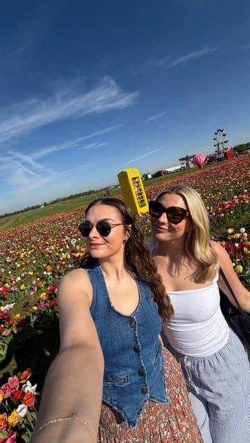 The video is a montage of a day out at Farmer Copleys, featuring shots of tulip fields, the farm shop, ice cream, and a milk vending machine, followed by a visit to a botanical garden. It captures a relaxed, aesthetic 'girly day' vibe.