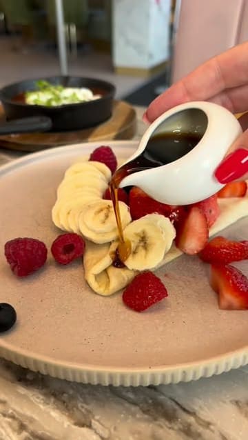 A promotional video for Heavenly Desserts, showcasing a variety of sweet and savoury menu items including crepes, matcha drinks, loaded tots, hummus, and shakshuka.