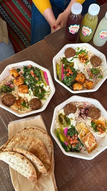 A short video showcasing a lunch mezze box at Comptoir Libanais, featuring halloumi, falafel, hummus, and salad, followed by a brief tour of the restaurant's colourful interior.