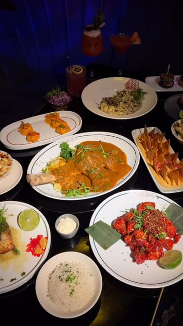 A high-quality promotional reel for The Banc, a North London restaurant and lounge. The video features a montage of signature dishes, including steak and pasta, alongside cocktail preparation and shots of the stylish, floral-decorated interior. It captures the transition from dining to the lounge atmosphere, including shisha.