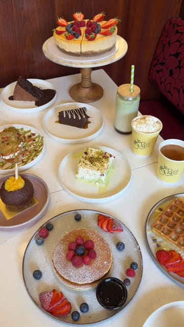 A fast-paced, high-energy montage showcasing a wide variety of desserts, street food, and drinks at a modern cafe. The video focuses on close-up shots of food preparation and presentation, highlighting the venue's aesthetic and menu diversity.
