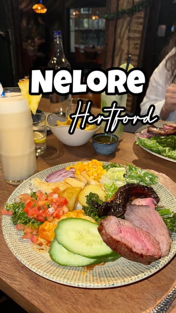 A short, punchy reel showcasing a visit to Nelore, a Brazilian steakhouse. The video features quick cuts of the menu, the buffet selection, close-ups of carved meats, and a cocktail toast, effectively capturing the 'rodizio' dining experience.
