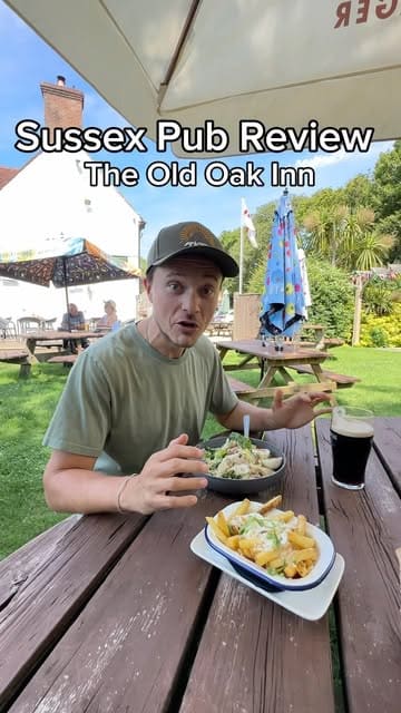A creator visits a local pub, The Old Oak Inn, to review the atmosphere and food, specifically trying the chicken caesar salad and parmesan truffle chips.
